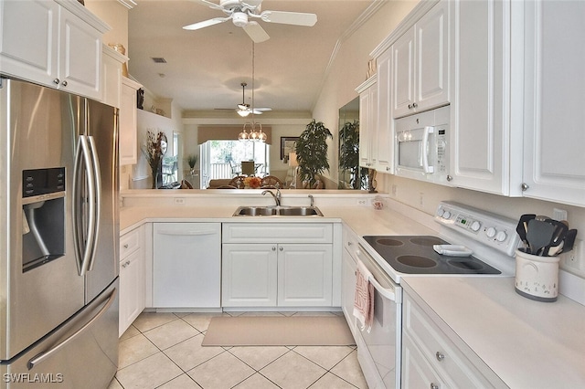 kitchen with sink, white cabinets, white appliances, and light tile patterned floors