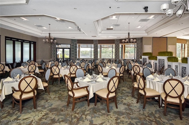 dining space featuring a chandelier, crown molding, and a tray ceiling