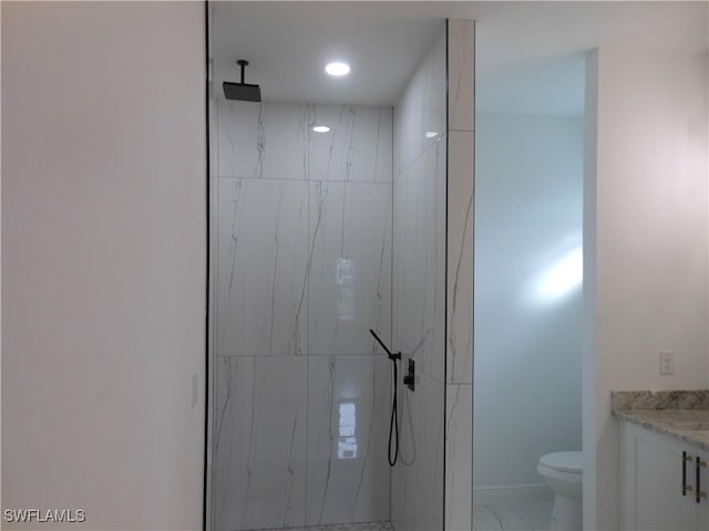 bathroom with marble finish floor, a marble finish shower, recessed lighting, toilet, and vanity