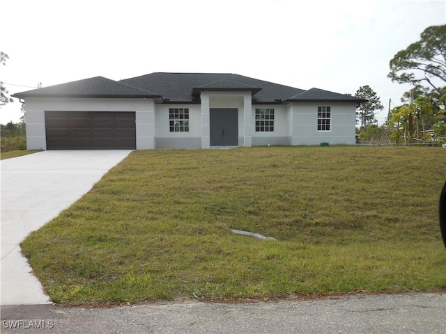 view of front of house with a garage, driveway, a front yard, and stucco siding