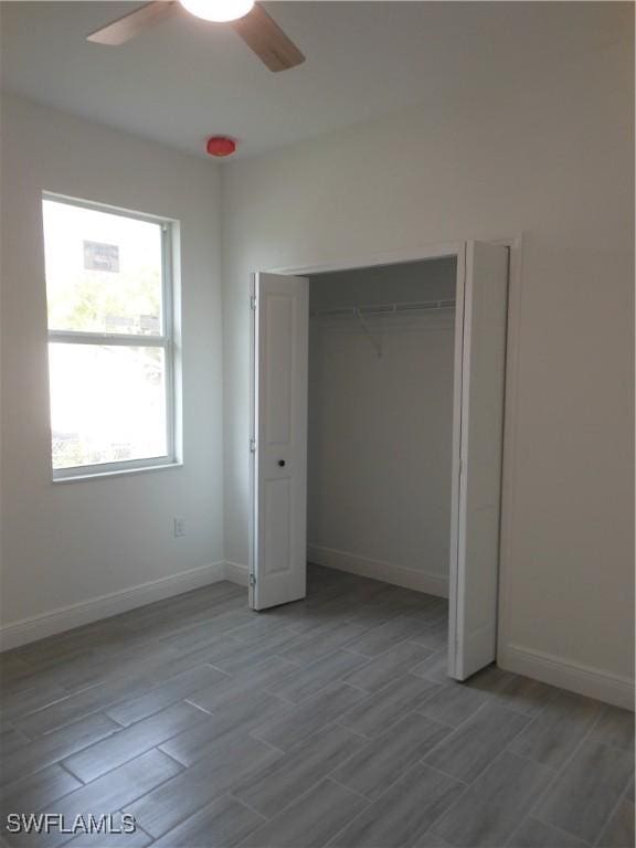 unfurnished bedroom with light hardwood / wood-style flooring, a closet, and ceiling fan