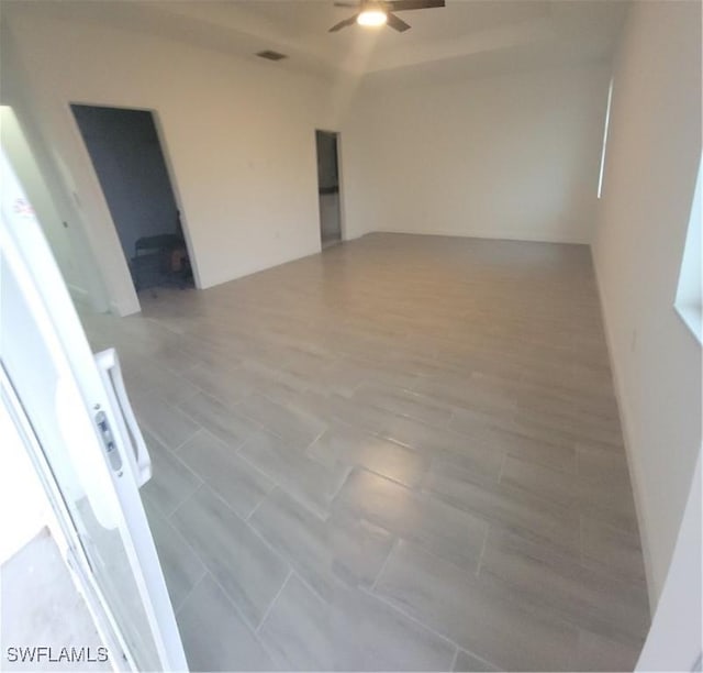 spare room featuring ceiling fan and visible vents