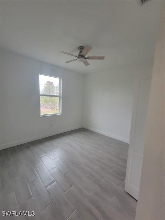 empty room featuring ceiling fan and light hardwood / wood-style flooring