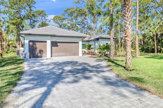 view of front of home with a garage and a front yard