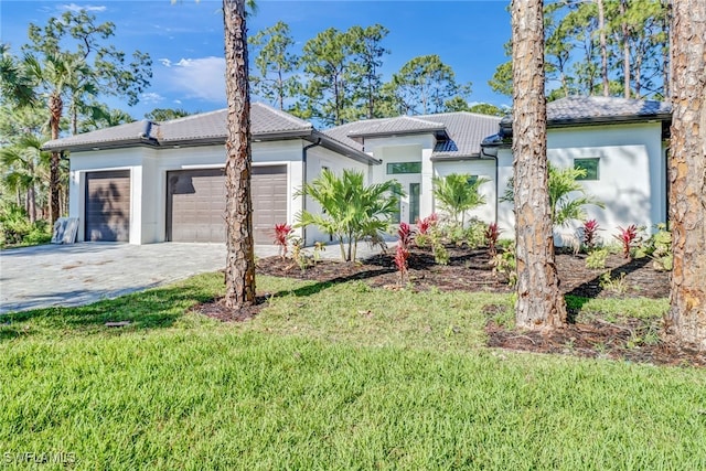 view of front of house with a front yard and a garage