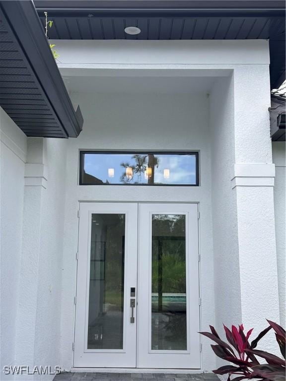 view of exterior entry featuring french doors