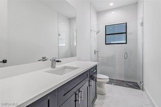 bathroom with a shower with door, vanity, and toilet