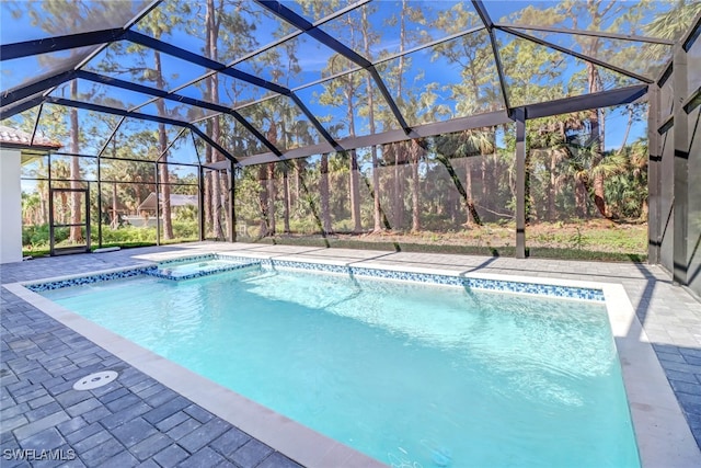 view of swimming pool with a patio area and a lanai