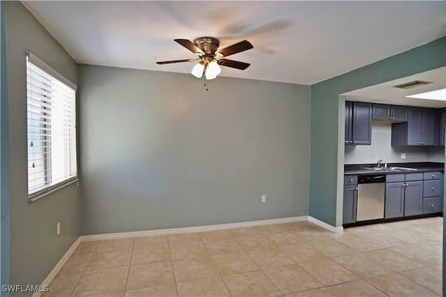 kitchen with stainless steel dishwasher, ceiling fan, light tile patterned flooring, and sink