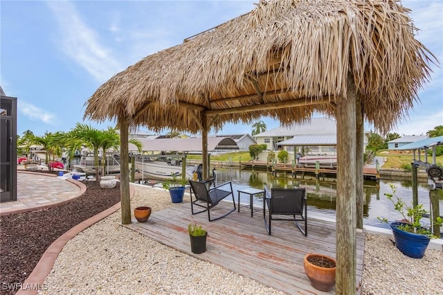 wooden deck featuring a boat dock and a water view