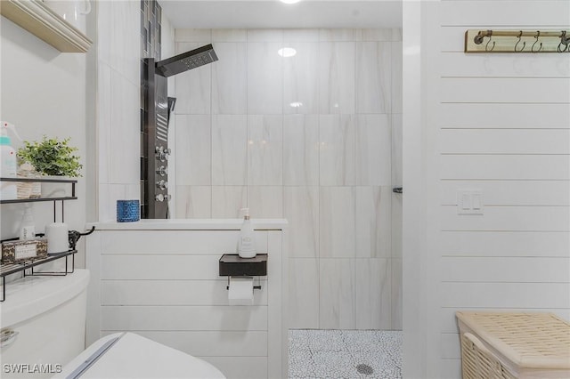 bathroom with tiled shower and toilet