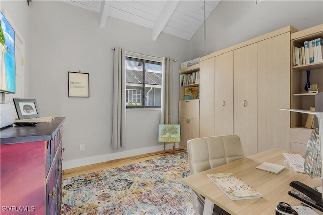 office space with wooden ceiling, lofted ceiling with beams, and light hardwood / wood-style floors