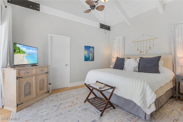 bedroom with lofted ceiling with beams, light hardwood / wood-style flooring, and ceiling fan