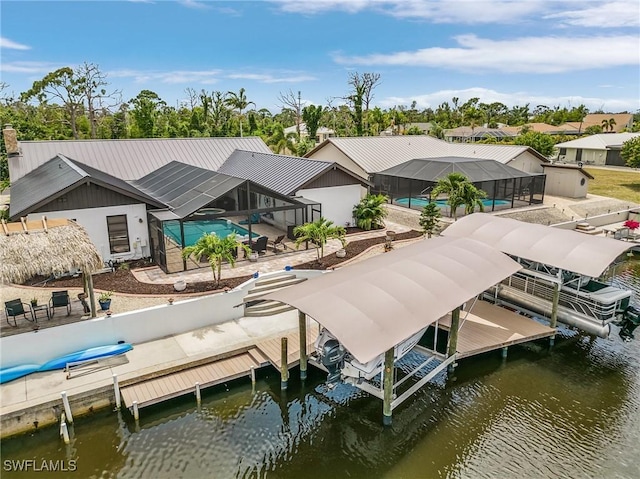 exterior space with a patio, a water view, and glass enclosure