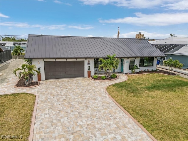 ranch-style home featuring a front lawn and a garage