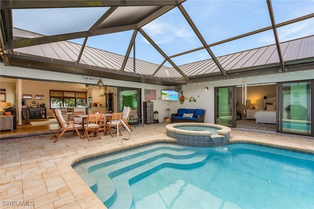 view of swimming pool with glass enclosure, an in ground hot tub, and a patio