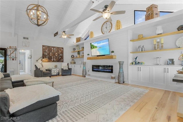 living room with high vaulted ceiling, ceiling fan with notable chandelier, light wood-type flooring, beamed ceiling, and a large fireplace