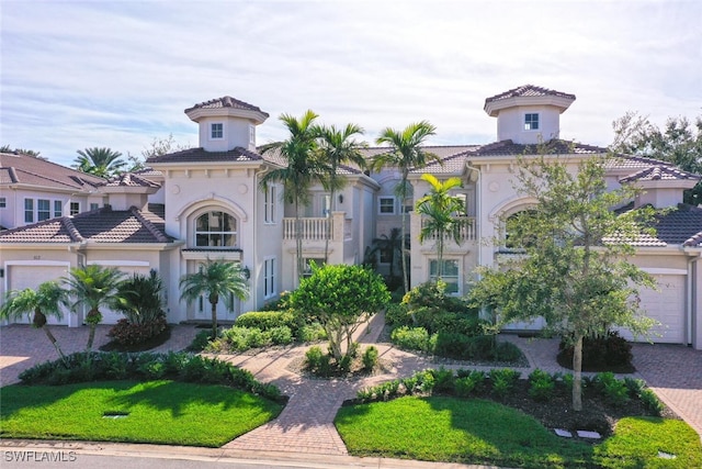 view of front of home with a balcony and a garage