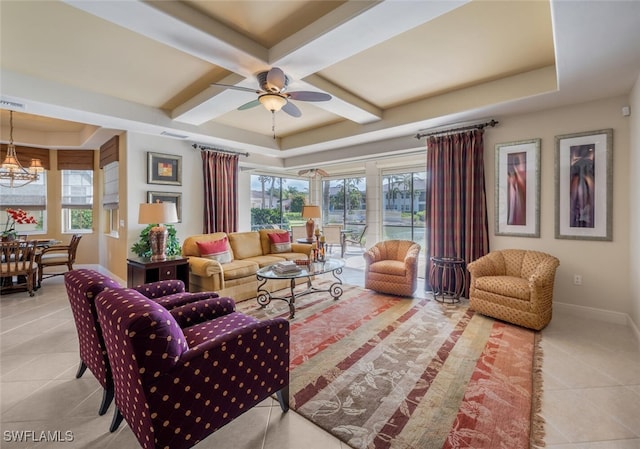 living room with light tile patterned floors, ceiling fan with notable chandelier, a healthy amount of sunlight, and coffered ceiling