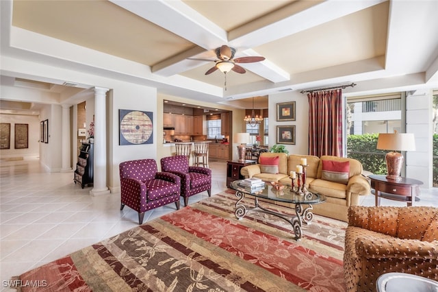 living room featuring plenty of natural light, light tile patterned floors, ceiling fan with notable chandelier, and ornate columns