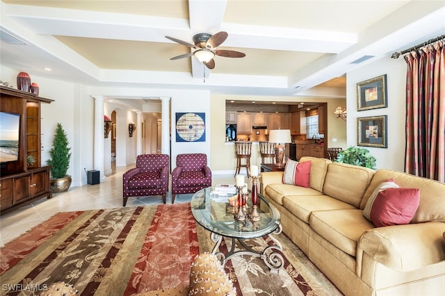 tiled living room featuring decorative columns and ceiling fan