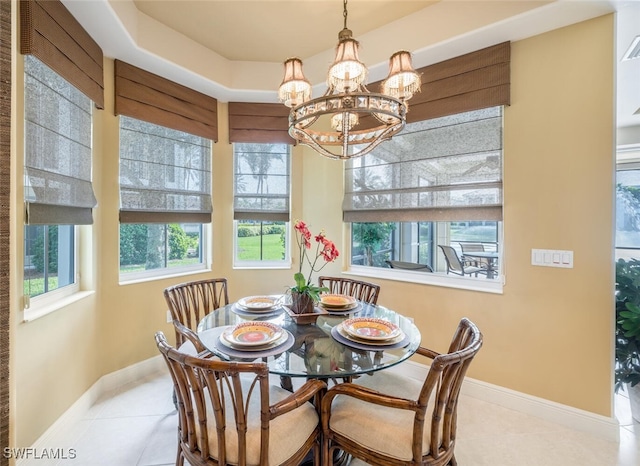 tiled dining area with a chandelier