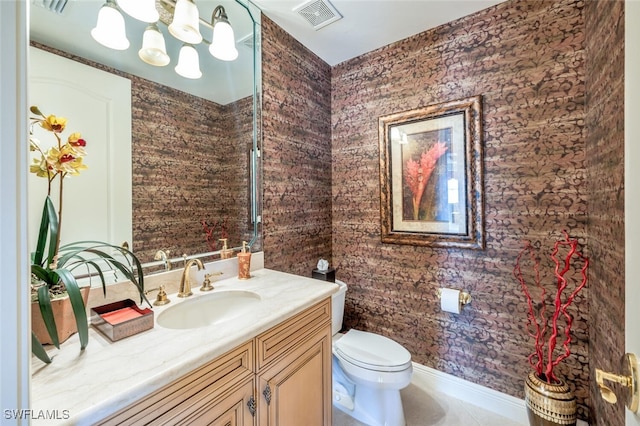 bathroom with tile patterned floors, vanity, and toilet