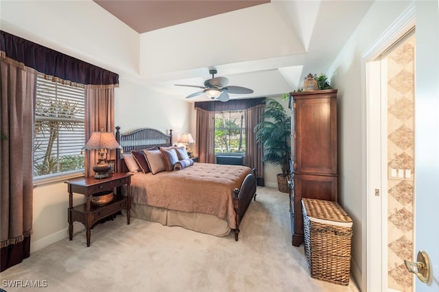 bedroom featuring connected bathroom, ceiling fan, and light carpet