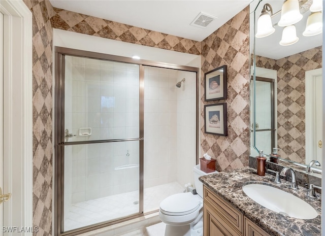 bathroom with vanity, toilet, walk in shower, and a notable chandelier