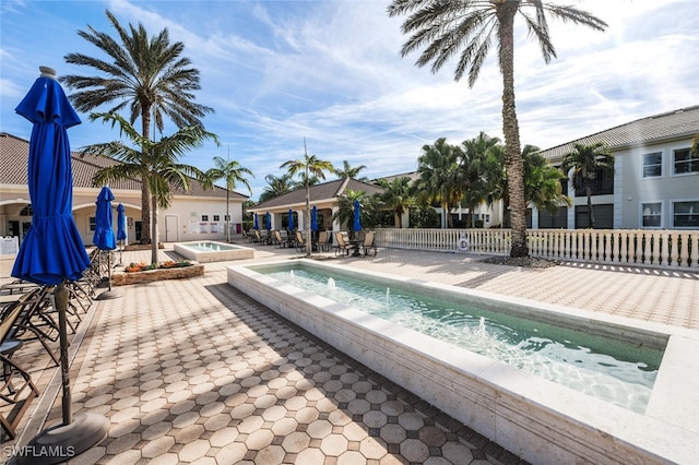 view of pool with an in ground hot tub and a patio