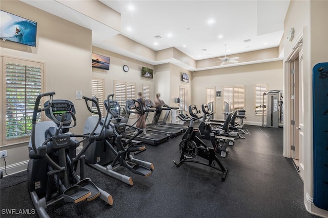 workout area with ceiling fan and a towering ceiling