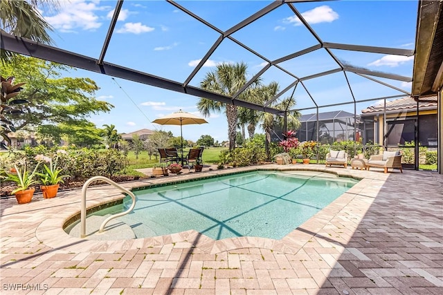 view of swimming pool featuring a lanai and a patio area