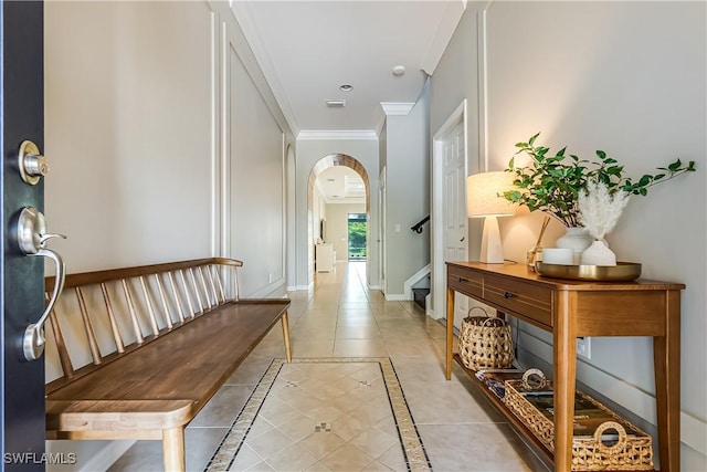 hall with light tile patterned floors and ornamental molding