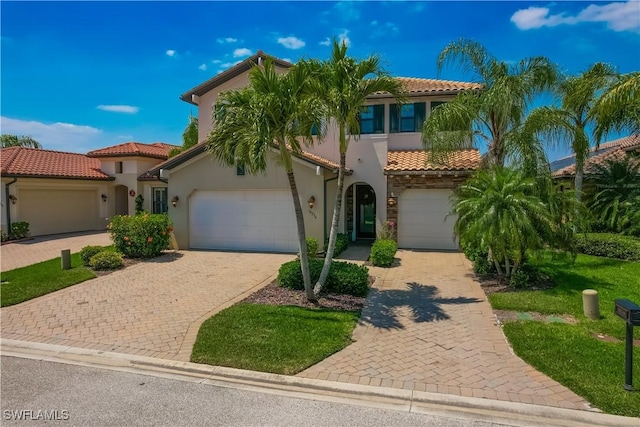 mediterranean / spanish home with a garage