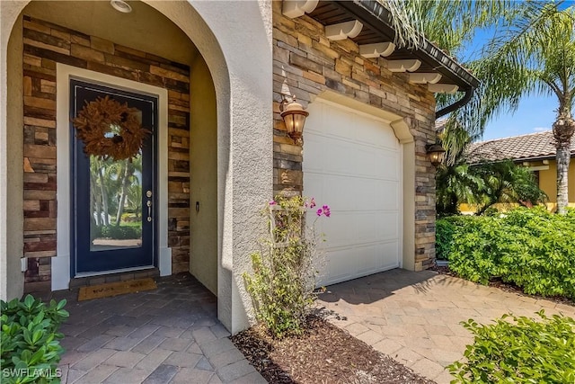 doorway to property with a garage