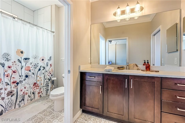 bathroom with a shower with curtain, tile patterned floors, crown molding, toilet, and vanity