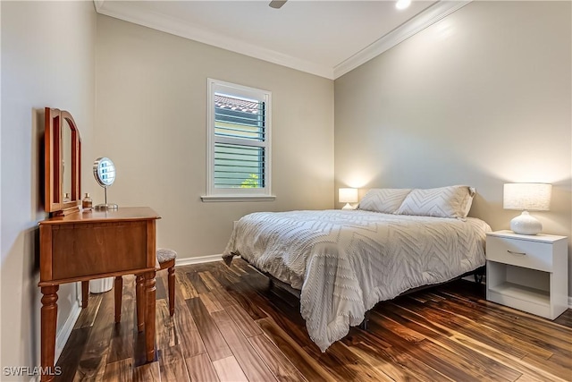 bedroom featuring ceiling fan, crown molding, and dark wood-type flooring