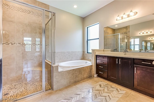 bathroom featuring tile patterned flooring, vanity, and independent shower and bath