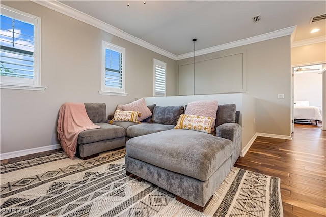 living room with hardwood / wood-style flooring, ceiling fan, and ornamental molding