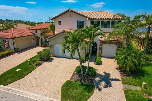 mediterranean / spanish home with a garage