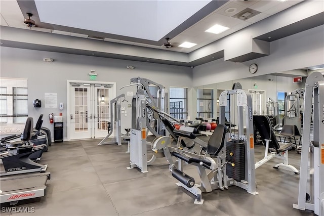 exercise room featuring a high ceiling and french doors