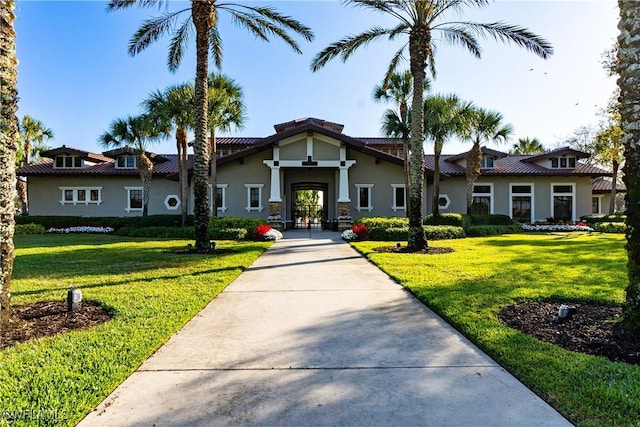 mediterranean / spanish home with a front yard