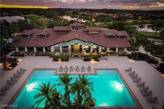 view of pool at dusk