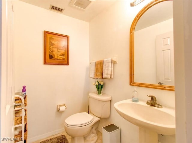 bathroom featuring tile patterned floors, toilet, and sink