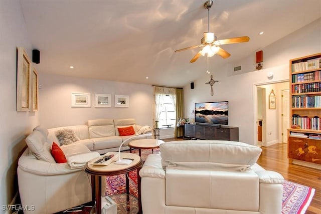 living room featuring light hardwood / wood-style floors, ceiling fan, and lofted ceiling