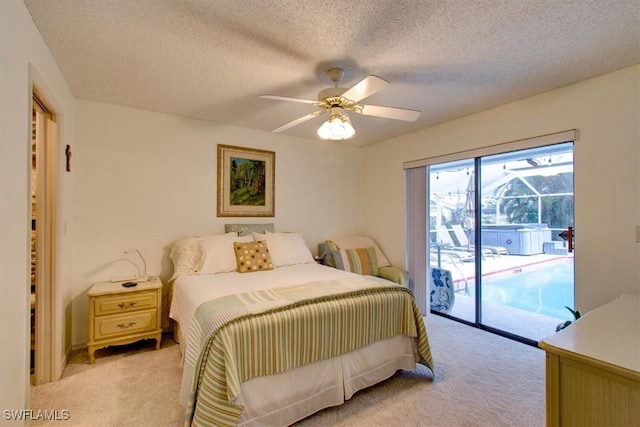 carpeted bedroom featuring ceiling fan, access to exterior, and a textured ceiling