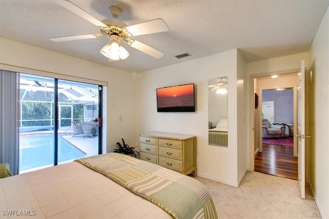 bedroom featuring access to exterior, ceiling fan, light colored carpet, and a textured ceiling