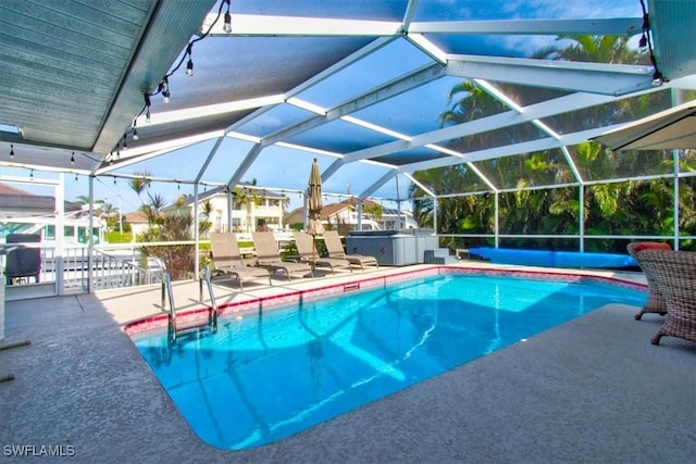 view of swimming pool featuring a patio and a lanai