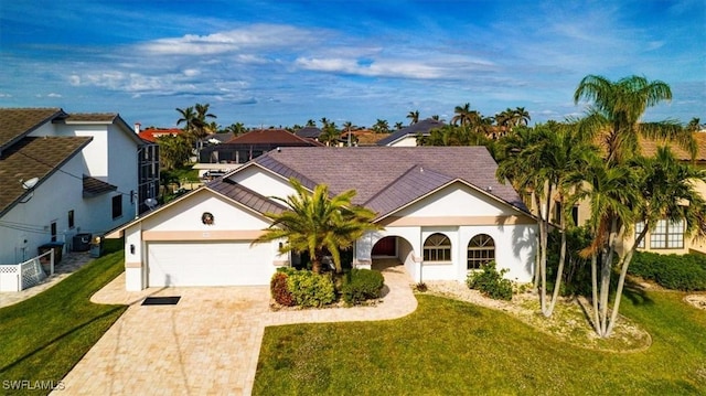 view of front of home featuring a front yard and a garage