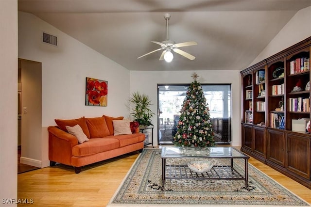 living room with light hardwood / wood-style flooring, ceiling fan, and lofted ceiling